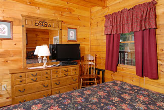 Cabin bedroom that features a television